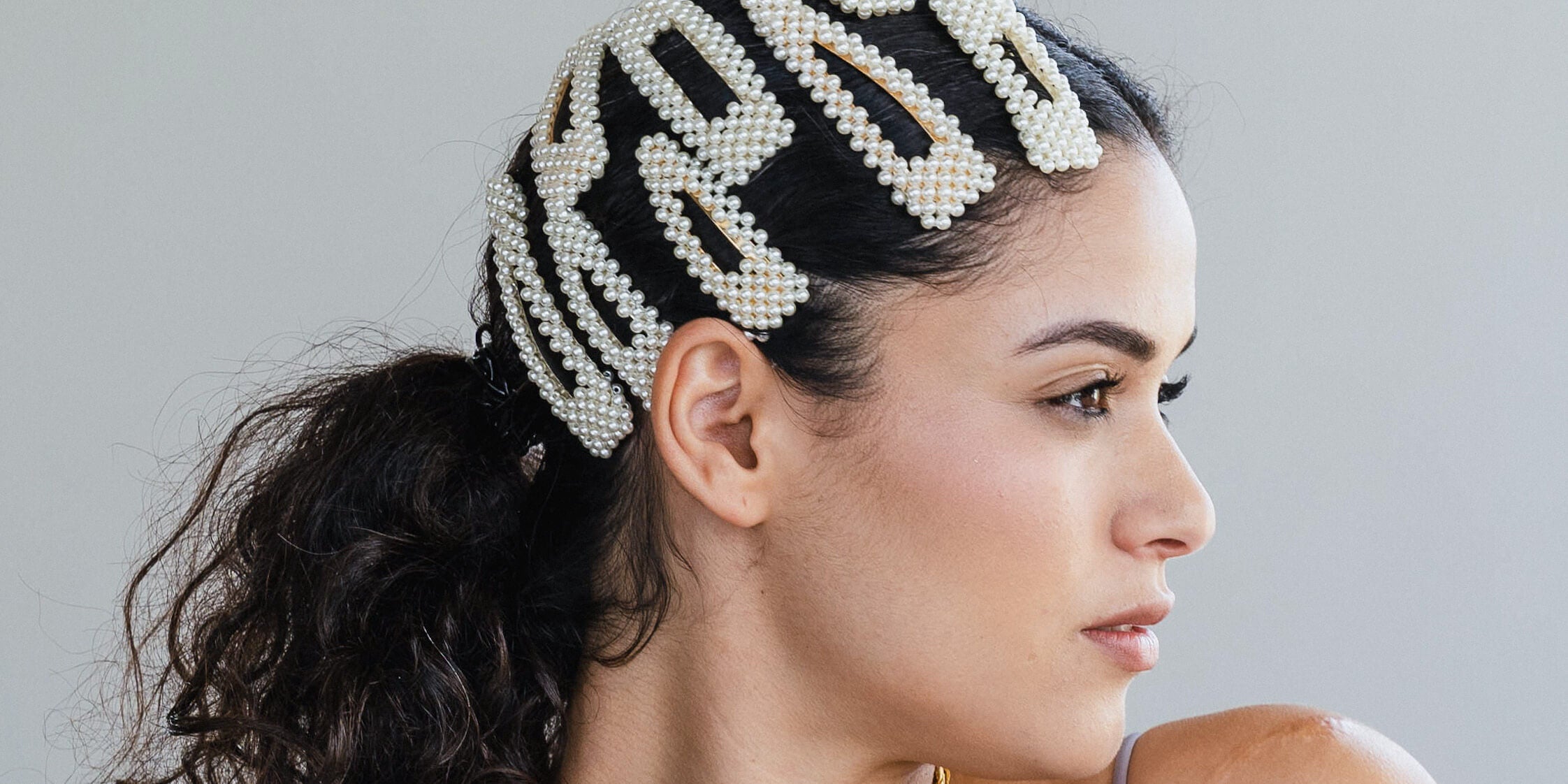 model is wearing pearl hair clips in her hair