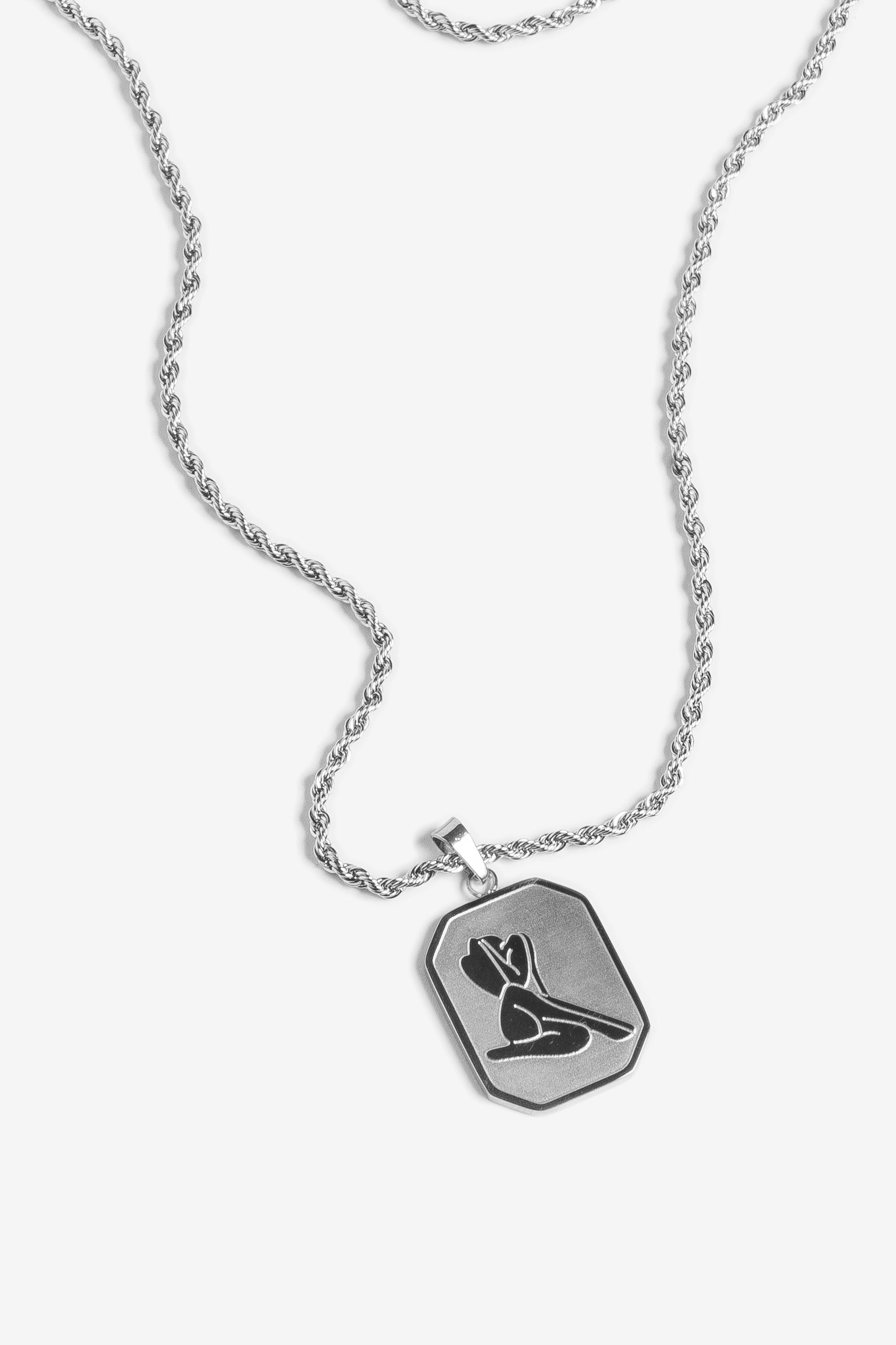 Image of a silver pendant necklace with a woman's figure on it on a white background