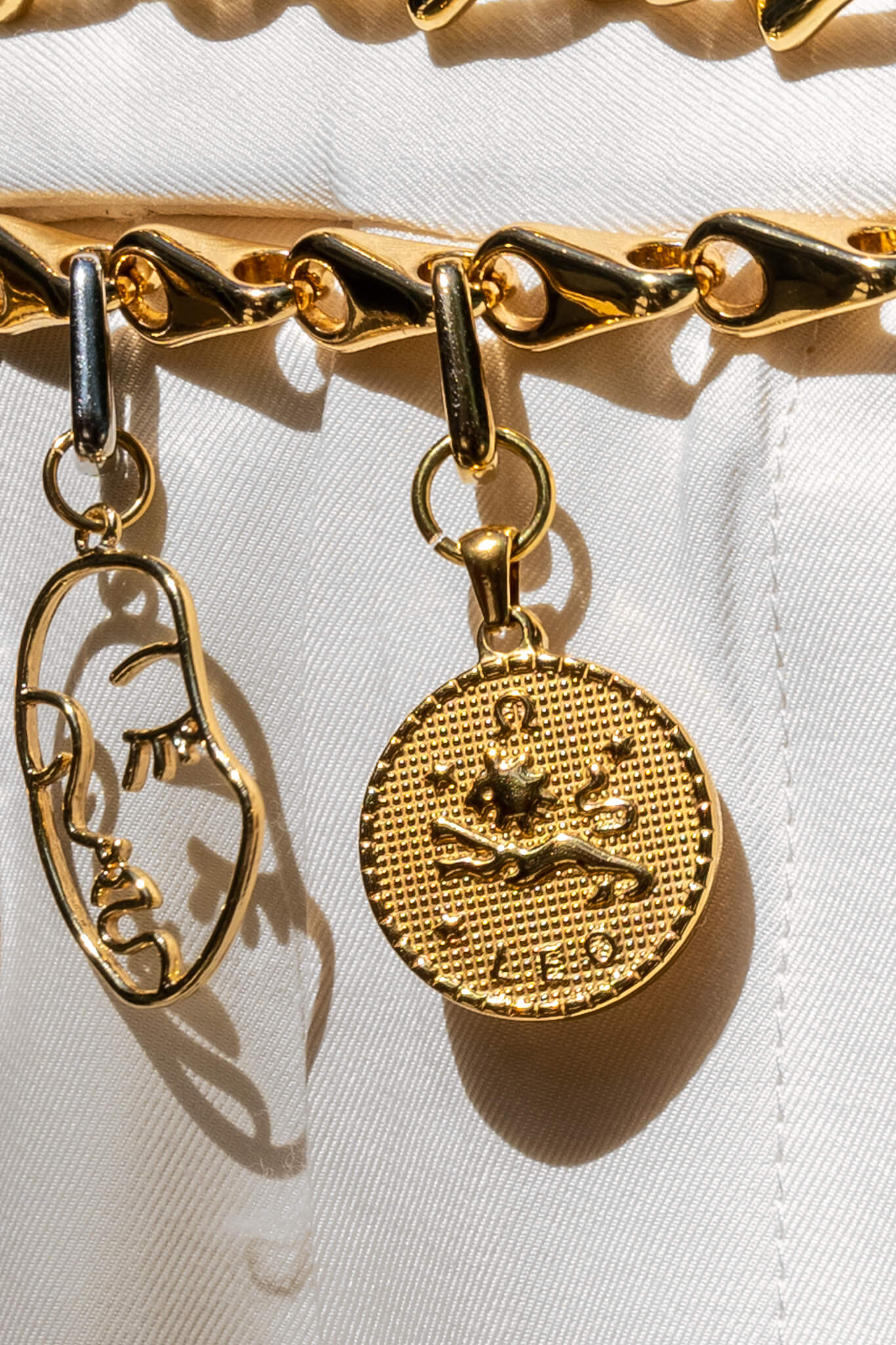 Zodiac gold coin charm clipped on a chain belt